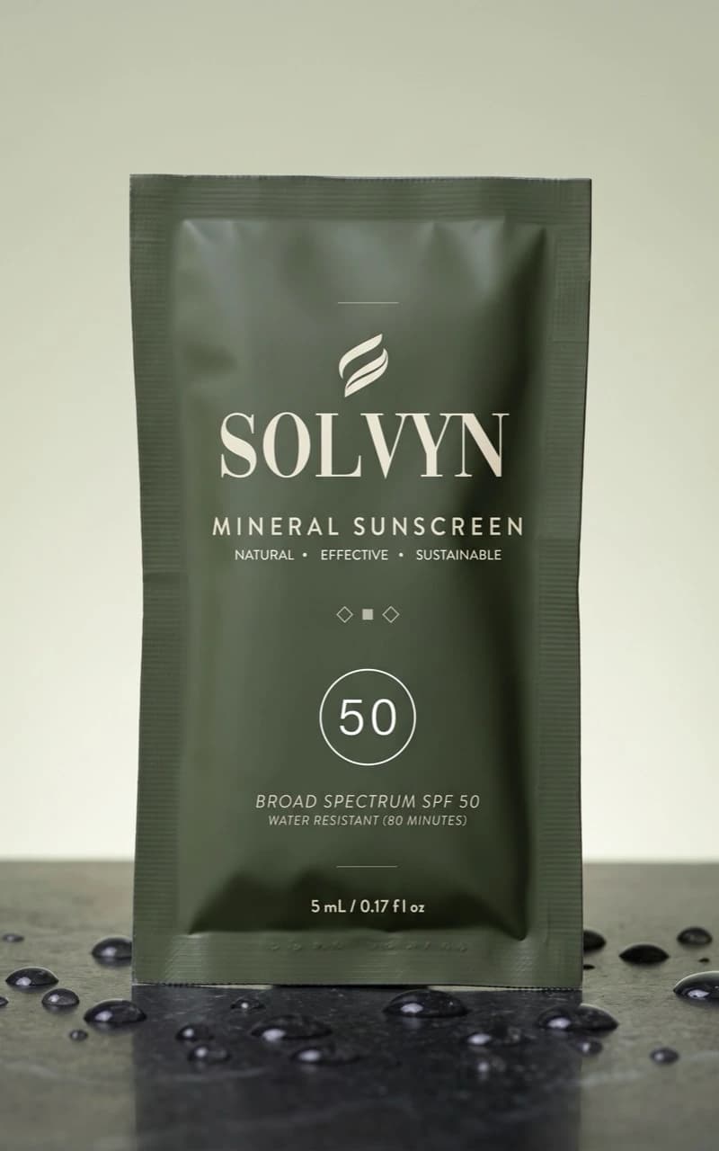 Solvyn Shield sachet resting on polished basalt stone
